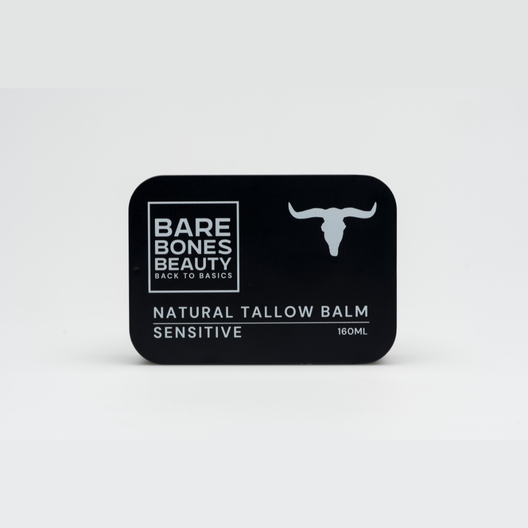 A black tin labeled "Sensitive Tallow Balm 160mL" from Bare Bones Beauty Australia, featuring a white bull head icon and formulated with organic tallow for deep hydration, sits on a plain grey background.