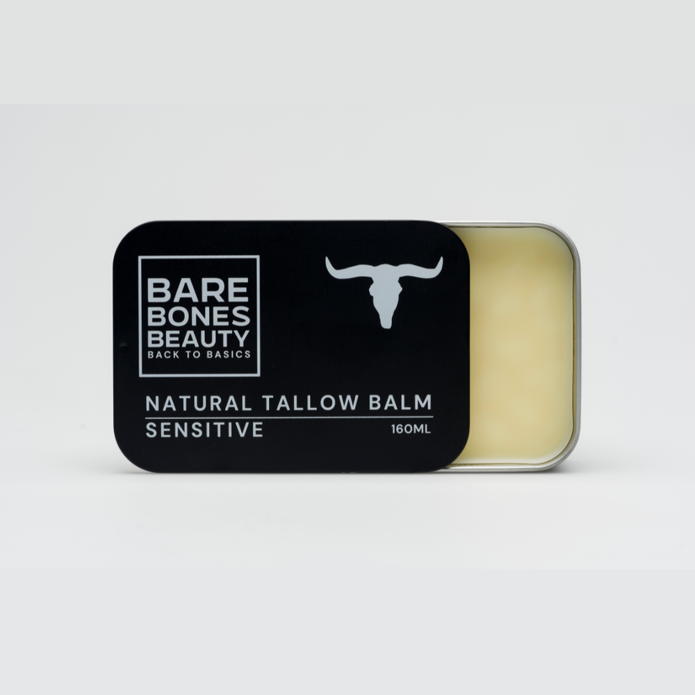 A rectangular tin labeled "Bare Bones Beauty Australia Sensitive Tallow Balm 160mL," featuring a bull head silhouette and partially open to reveal light yellow balm, rests on a plain white background.
