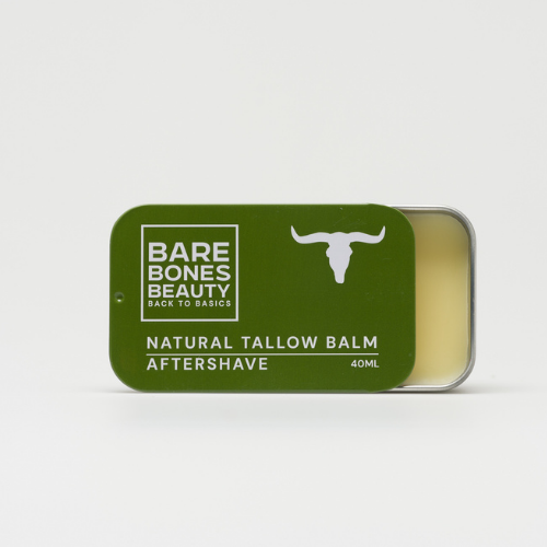 A rectangular tin of Bare Bones Beauty Australia Aftershave Balm, 40ml, with a green lid and white bull head logo. The tin is partially open to show the pale balm inside—a natural aftershave and moisturiser.