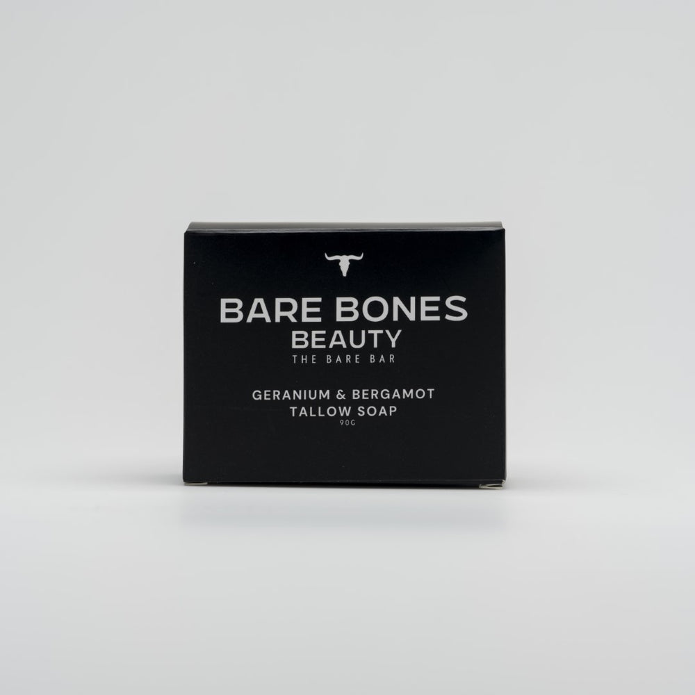 A black box of Bare Bones Beauty Australia’s The BARE bar – Tallow Soap, with white text and a small bull logo, sits on a light gray background—ideal for moisturizing or pairing with an exfoliating bag.