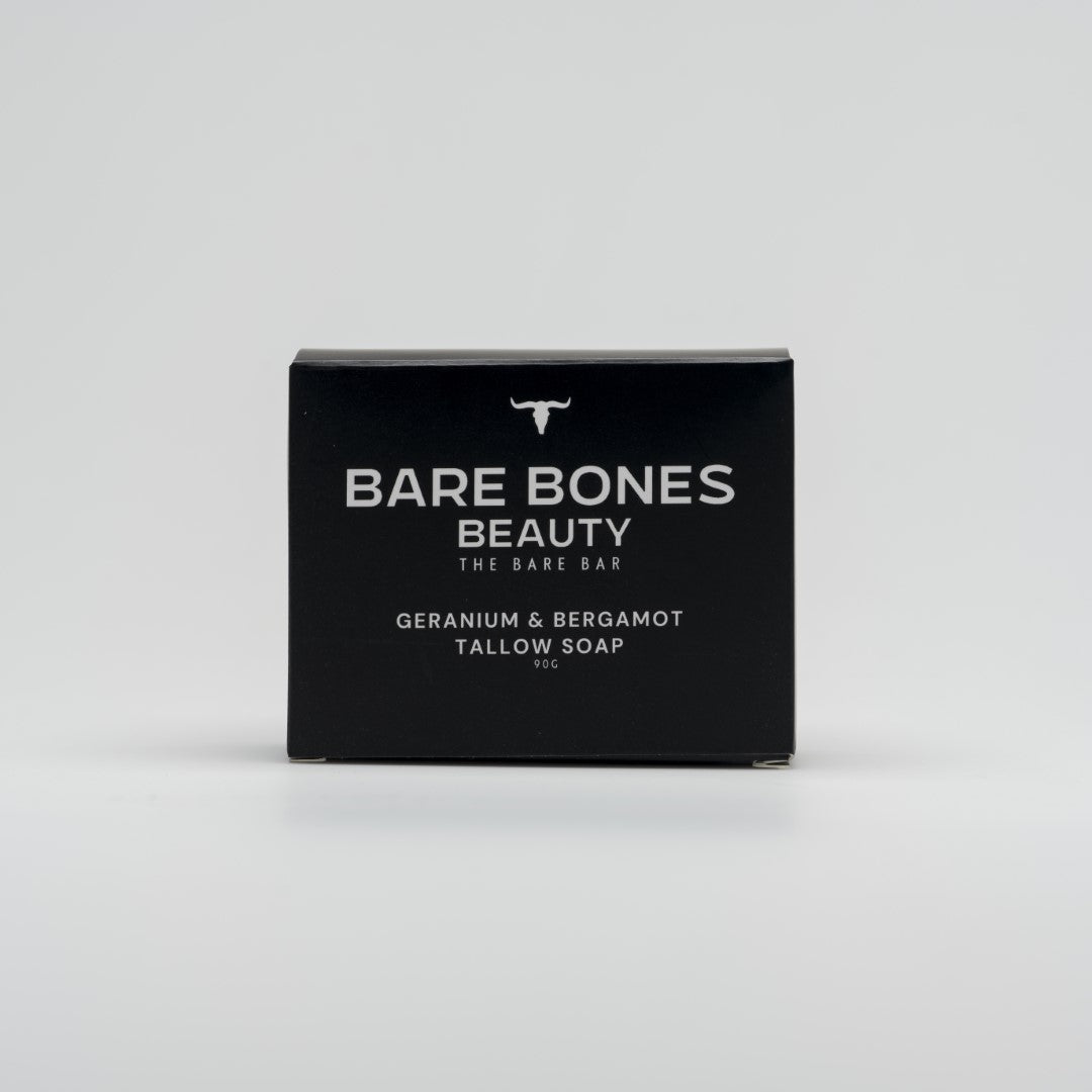 A black box of Bare Bones Beauty Australia’s The BARE bar – Tallow Soap, with white text and a small bull logo, sits on a light gray background—ideal for moisturizing or pairing with an exfoliating bag.
