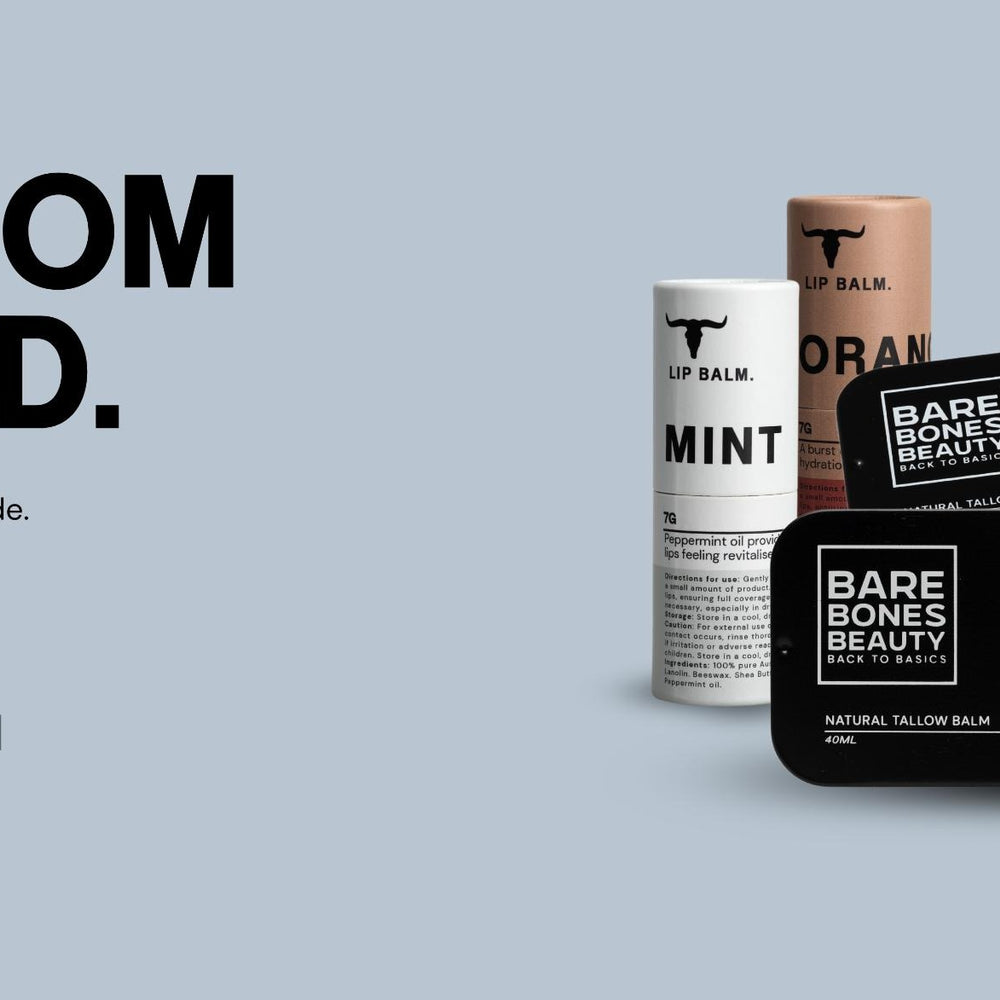 A display of Bare Bones Beauty lip balms and tins in assorted flavors with bold text reading “Built from the wild.” Bullet points highlight natural benefits, hydration, and versatile care. A badge says, “Heals Hydrates Protects.”.