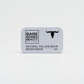 A rectangular tin labeled "Beach Balm" by Bare Bones Beauty Australia features a black cow skull silhouette and provides natural skin protection with non-nanoparticle zinc oxide, shown on a plain white background.