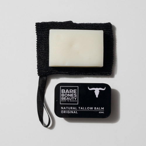 The Soap & Balm Bundle by Bare Bones Beauty Australia features a white rectangular tallow soap on a black textured cloth and a black tin of Organic Tallow Balm with a bull head logo—ideal for your natural skincare routine.