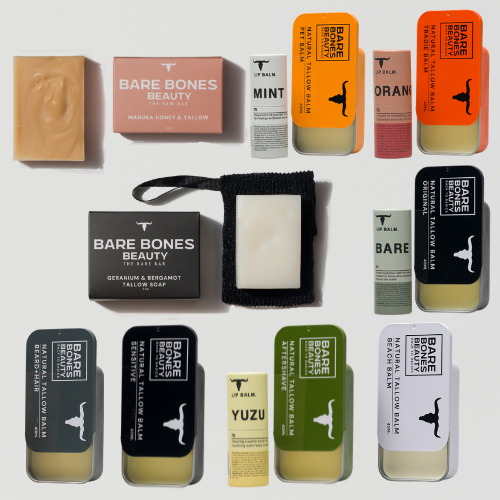 A flat lay of Bare Bones Beauty Australia’s EVERY SINGLE BONE – Bundle, showcasing boxed bar soaps and UP Balm tins (mint, orange, yuzu, original) plus a bar soap on a black textured saver—ideal for nourishing your lips and skin.
