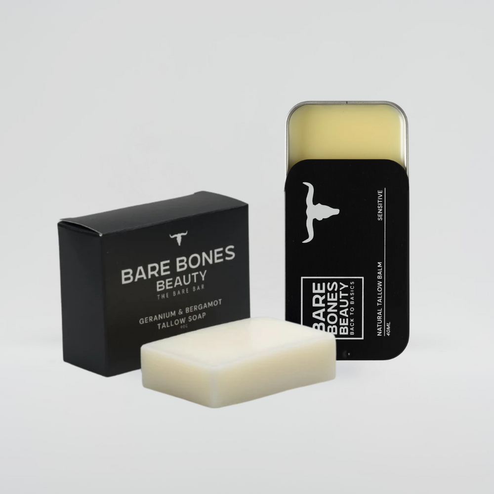 
                  
                    A black Bare Bones Beauty Australia box sits beside an unwrapped Soap & Balm Bundle, with a black tin of natural lip balm partially open to show the product. Both containers display minimalist white text and logo.
                  
                