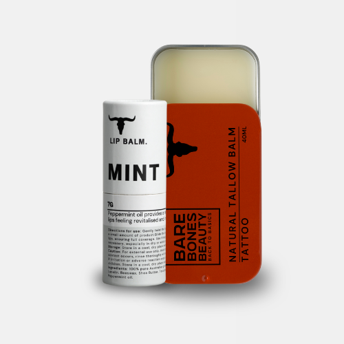 
                  
                    A white lip balm tube and a rectangular orange tin from Bare Bones Beauty Australia make up the Tallow Balm & Lip Balm Bundle, with the tin lid partially open to show the Organic Tallow Balm—ideal for natural skin care.
                  
                